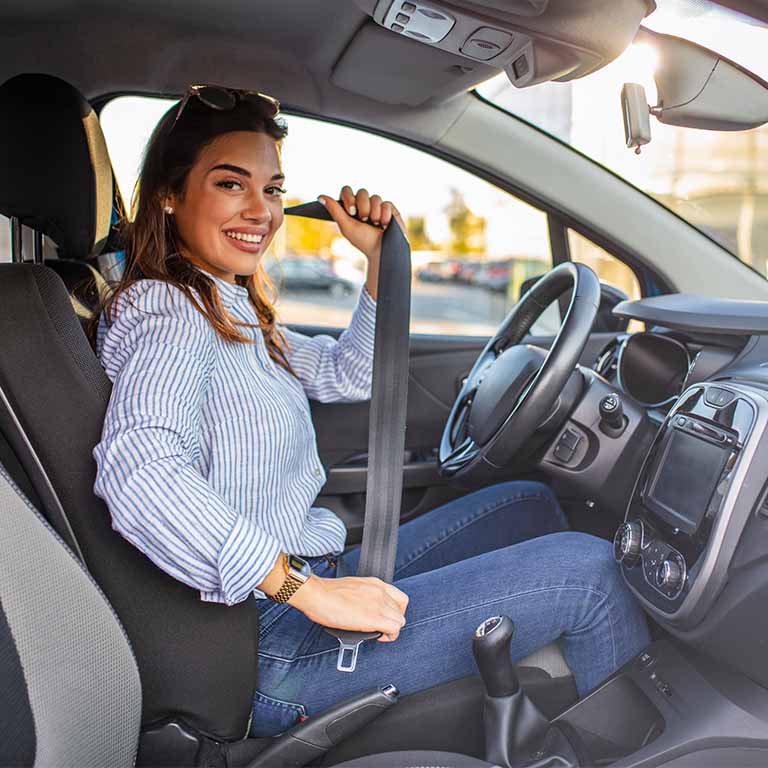 Woman Putting Seatbelt On